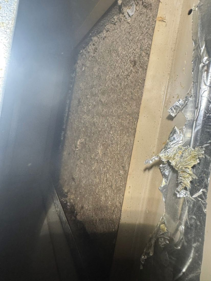 Evaporator coil before cleaning — showing heavy dust accumulation