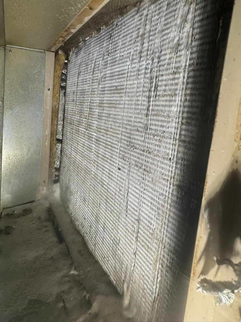 Evaporator coil being serviced during maintenance