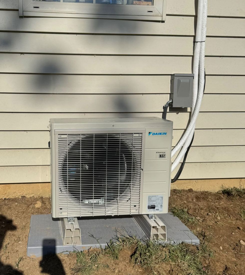 Daikin mini-split outdoor unit mounted on exterior wall